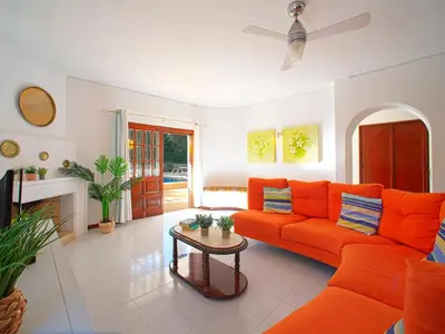a living room with orange furniture and a fireplace at Villa Maria by Interhome in Albufeira