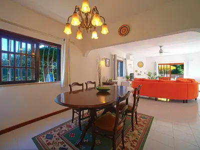 a dining room and living room with a table and chairs at Villa Maria by Interhome in Albufeira