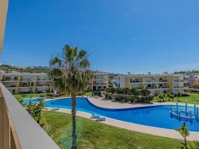 a large swimming pool in front of a building at Apartment Jardins Marina T2 - VIP Properties by Interhome in Albufeira