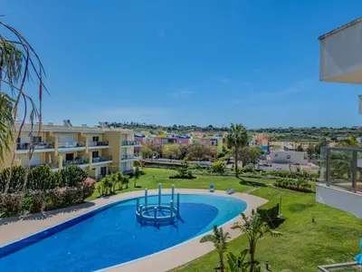 a large swimming pool in front of a building at Apartment Jardins Marina T2 - VIP Properties by Interhome in Albufeira