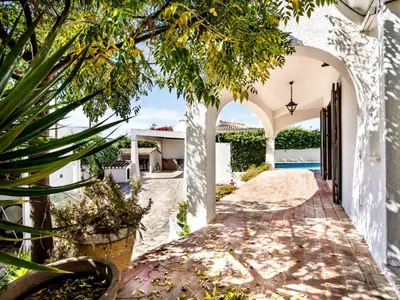a patio with a table and chairs next to a swimming pool at Villa Libertos V4 - VIP Properties by Interhome in Albufeira