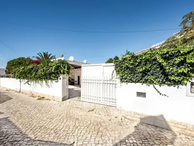 a patio with a table and a pizza oven at Villa Libertos V4 - VIP Properties by Interhome in Albufeira