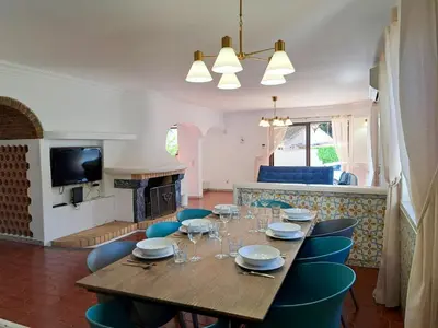 a dining room with a wooden table and chairs at Villa Libertos V4 - VIP Properties by Interhome in Albufeira