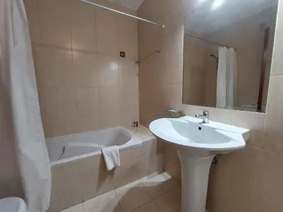 a bathroom with a sink and a bath tub and a sink at Loule Turtle by SAPvillas in Vilamoura