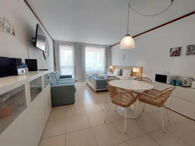 a living room with a couch and a table and chairs at Loule Turtle by SAPvillas in Vilamoura