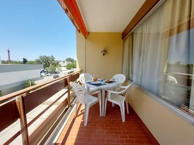 a balcony with a table and chairs and a window at Loule Turtle by SAPvillas in Vilamoura