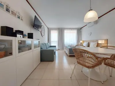 a living room with a table and a couch at Loule Turtle by SAPvillas in Vilamoura