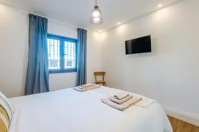 a bedroom with a bed with two towels on it at Balaia apartment at Albufeira in Albufeira