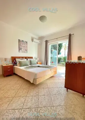 a bedroom with a bed and a sliding glass door at Orquidea Senses - 6 Pax - Sea View in Albufeira