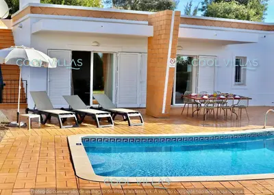 a villa with a swimming pool and a table and chairs at Orquidea Senses - 6 Pax - Sea View in Albufeira