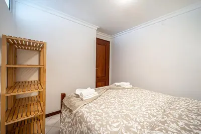 a small bedroom with a bed and a wooden shelf at Vilamoura Sea View in Vilamoura