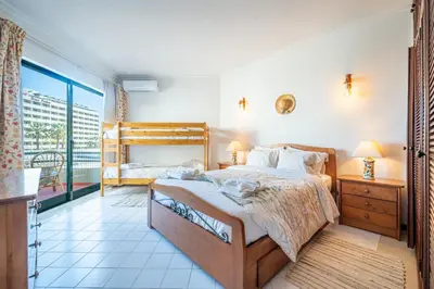 a bedroom with a bed and a balcony at Vilamoura Sea View in Vilamoura