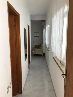 a room with two beds and a table with a lamp at Apartment near the ocean Rua 5 de Outubro in Albufeira