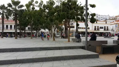 a beach with people and the ocean and buildings at Apartment near the ocean Rua 5 de Outubro in Albufeira