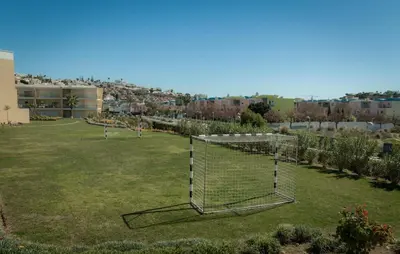a soccer field with a goal in the grass at Sir Anthony Luxury in Albufeira