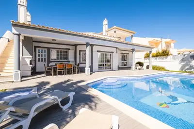 a villa with a swimming pool and a house at Villa Ventura Heritage in Albufeira