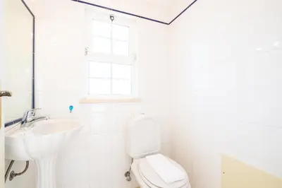 a white bathroom with a sink and a toilet at Villa Ventura Heritage in Albufeira