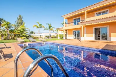 a swimming pool in front of a house at VILLA Simao in Guia