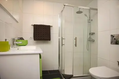 a bathroom with a shower and a toilet and a sink at Geneve Old Town Apartment in Albufeira