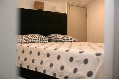 a bed with polka dot pillows in a bedroom at Geneve Old Town Apartment in Albufeira