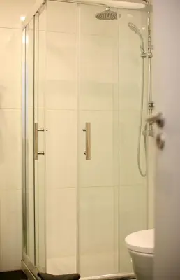a shower with a glass door in a bathroom at Geneve Old Town Apartment in Albufeira