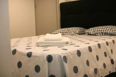 a bed with two towels on a polka dot table cloth at Geneve Old Town Apartment in Albufeira
