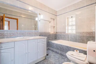a bathroom with a tub and a toilet and a sink at VILLA LINDA Palace in Guia