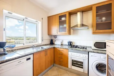 a kitchen with a sink and a window at Milene Guest House in Albufeira