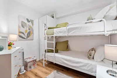 a bedroom with two bunk beds and a desk at Deluxe Flat by Albufeira Holidays in Albufeira