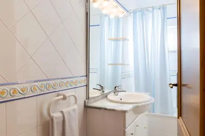 a bathroom with a sink and a mirror at Albufeira Marina Villa by Umbral in Albufeira