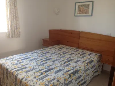 a bedroom with a bed with a comforter on it at Albufeira Marina Villa by Umbral in Albufeira