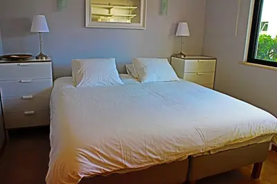 a bedroom with a large white bed with two night stands at Stunning 3 bed Villa in Vale do Lobo with Resort Membership 3 mins From Beach and Golf in Loulé