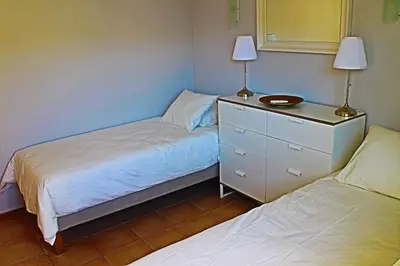 a bedroom with two beds and a dresser with a mirror at Stunning 3 bed Villa in Vale do Lobo with Resort Membership 3 mins From Beach and Golf in Loulé