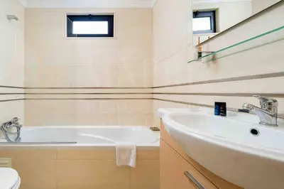 a bathroom with a white tub and a sink at Stunning 3 bed Villa in Vale do Lobo with Resort Membership 3 mins From Beach and Golf in Loulé