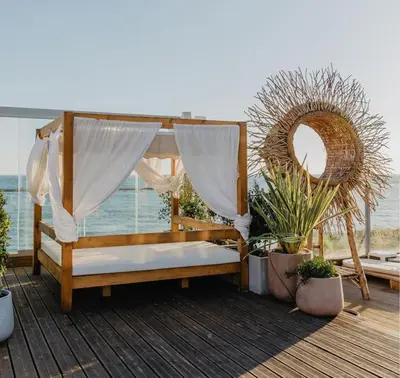a bed on a deck with plants and a window at Stunning 3 bed Villa in Vale do Lobo with Resort Membership 3 mins From Beach and Golf in Loulé