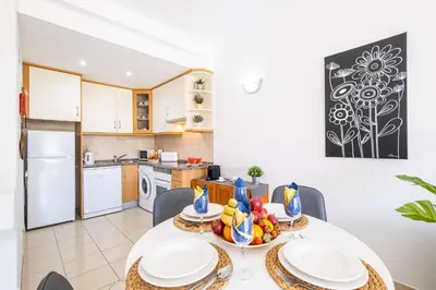a kitchen and dining room with a table and chairs at Apartment Venice by Algarve Vacation in Albufeira