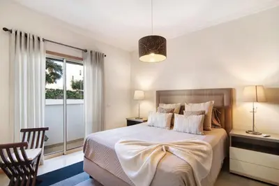 a bedroom with a bed and a window at Apartamento da Ourada Marina luz in Albufeira