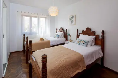 a bedroom with two beds and a chandelier at Apartments in Albufeira - Old Town in Albufeira