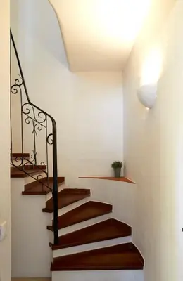 a staircase in a house with wooden stairs and a ceiling at Apartments in Albufeira - Old Town in Albufeira