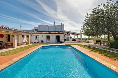 a swimming pool in front of a house at Casal dos Machados - Vista Mar in Benfarras