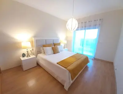 a bedroom with a large bed and a large window at Apartamento Loft 39 by Sunnyway in Albufeira