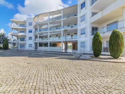 a white apartment building with a cobblestone street at Apartamento Loft 39 by Sunnyway in Albufeira