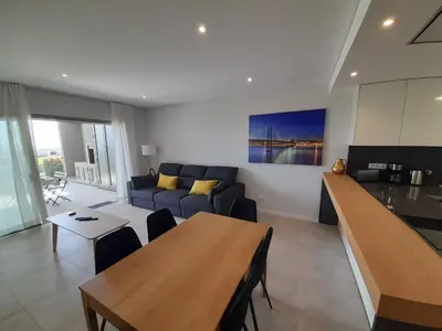 a living room with a couch and a table at @Rocking Apartments - Quinta da Alvorada in Albufeira