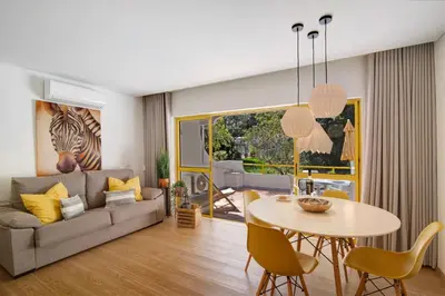 a living room with a couch and a table at África Minha in Vilamoura
