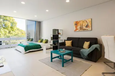 a living room with a couch and a bed at MARC - Vilamoura in Vilamoura