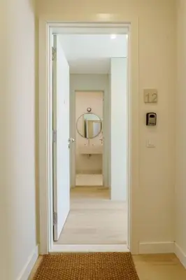 a hallway with a mirror and a hallway with a bathroom at Modern & Bright Faro Mercado Apt 12 by Lisbeyond in Faro