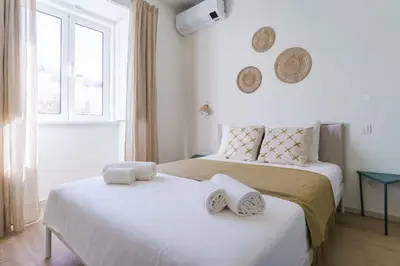 a bedroom with two beds with towels on them at Modern & Bright Faro Mercado Apt 12 by Lisbeyond in Faro