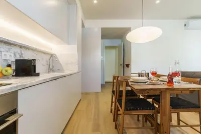 a kitchen and dining room with a table and chairs at Modern & Cozy Faro Mercado Apt 11 by Lisbeyond in Faro