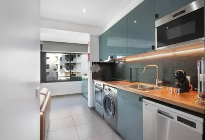 a kitchen with a sink and a washing machine at Cosy Loft in Vilamoura in Vilamoura