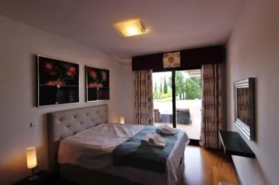 a bedroom with a bed and a large window at Monte Laguna Apartment in Quarteira